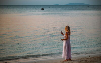 Woman on the phone on a beach