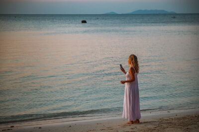 Woman on the phone on a beach