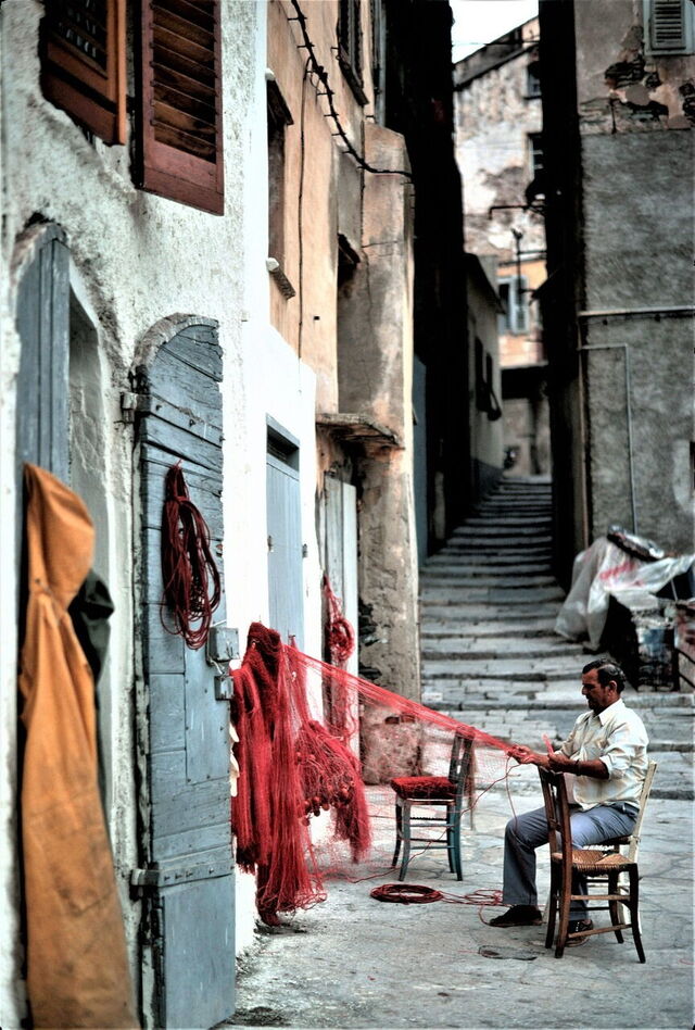 Man repairing a fishing net in Corsica