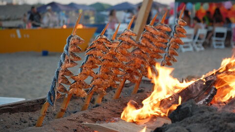 Grilling fish on the beach