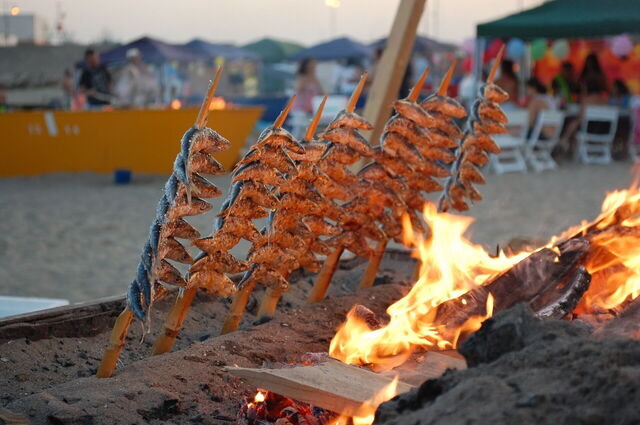 Grilling fish on the beach