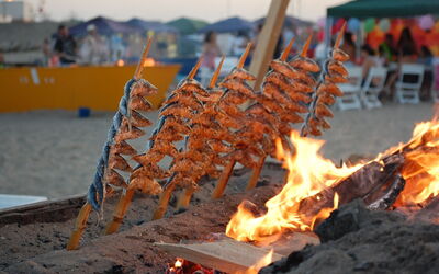 Grilling fish on the beach