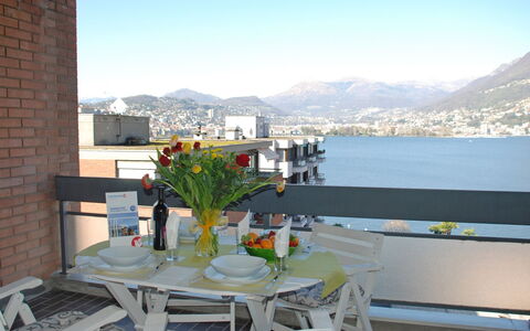 App. Paradiso: Sky, Water, Table, Building, Property, Furniture, Mountain, Tableware, Flowerpot, Flower