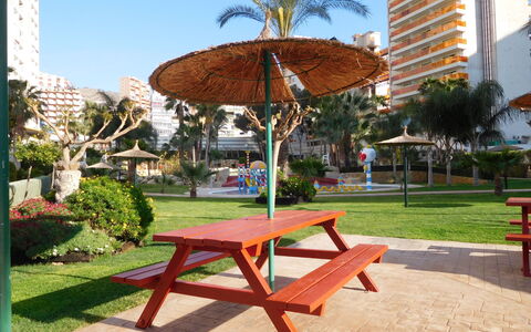 Gemelos: Plant, Building, Sky, Furniture, Tree, Shade, Table, Rectangle, Outdoor Furniture, Arecales