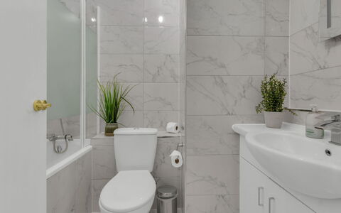 Globe View: Toilet Seat, Bathroom, Toilet, Plumbing Fixture, Wall, Flooring, Interior Design, Floor, Sink, Bathroom Cabinet