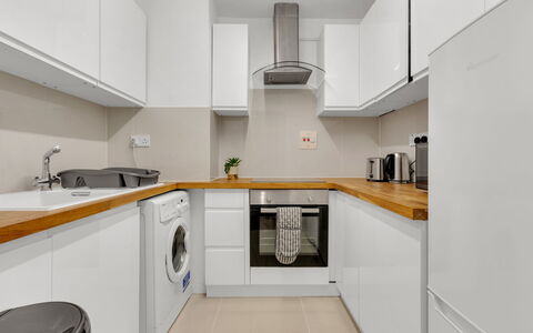 Globe View: Countertop, Kitchen, Flooring, Major Appliance, Interior Design, Kitchen Appliance, Cabinetry, Floor, Wood, Ceiling