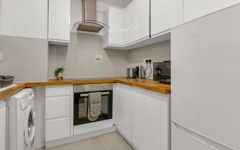 Globe View: Kitchen, Countertop, Kitchen Appliance, Flooring, Cabinetry, Major Appliance, Interior Design, Wood, Floor, Ceiling