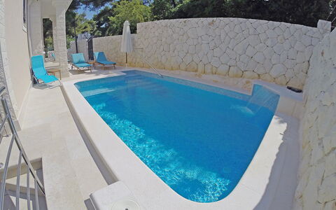 Villa Mustra: Water, Building, Swimming Pool, Azure, Plant, Outdoor Furniture, Rectangle, House, Chair, Shade