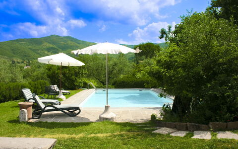 Collina dei Fiori: Swimming Pool, Hill, Outdoor Furniture, Mountain Range, Leisure, Eco Hotel, Umbrella, Resort, Garden, Shade