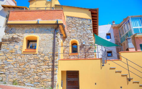 House of Stone - Deglio Faraldi: Blue, Property, House, Yellow, Building, Town, Neighbourhood, Real Estate, Home, Wall