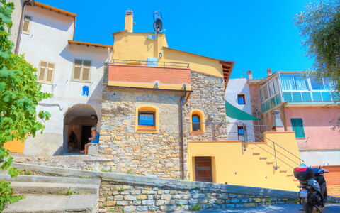 House of Stone - Deglio Faraldi: Blue, Town, Yellow, Neighbourhood, Property, House, Azure, Wall, Sky, Building