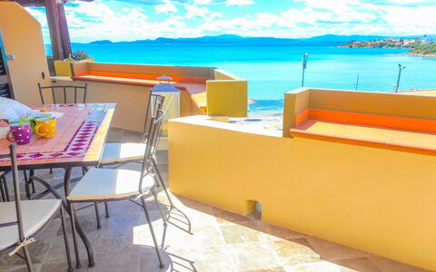 Golfo Aranci Ortensia Apartments: Property, Yellow, Room, Turquoise, Furniture, Vacation, Building, Table, Interior Design, Balcony