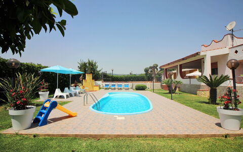 Andrea: Plant, Water, Sky, Flowerpot, Swimming Pool, Shade, Outdoor Furniture, Building, Tree, Arecales