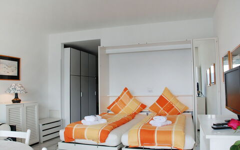 Vista Lago: Furniture, Room, Orange, Bedroom, White, Bed, Property, Interior Design, Wall, Yellow