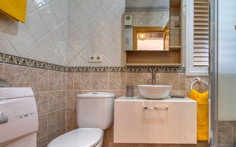 La Felicidad: Bathroom, Property, Tile, Room, Toilet, Floor, Yellow, Interior Design, Sink, Toilet Seat