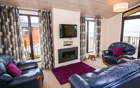 Loch Leven Lodge: Furniture, Couch, Television, Comfort, Picture Frame, Purple, Window, Living Room, Wood, Floor