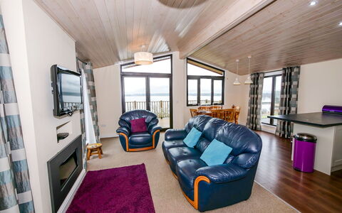 Loch Leven Lodge: Furniture, Building, Property, Couch, Comfort, Table, Purple, Lighting, Wood, Interior Design