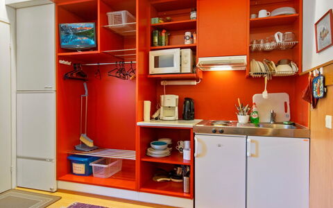 Vuosselin Helmi C25: Red, Kitchen, Furniture, Interior Design, Orange, Flooring, Floor, Cabinetry, Room, Cupboard