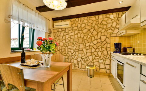 Divna: Table, Property, Cabinetry, Furniture, Flower, Plant, Countertop, Interior Design, Lighting, Wood
