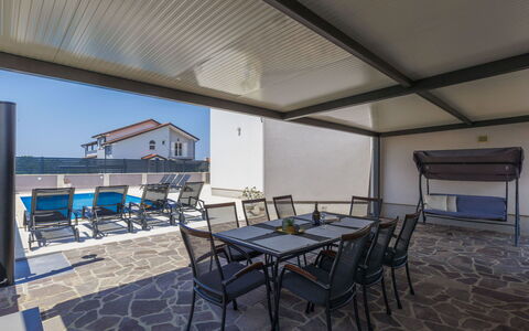 Villa Gocci: Table, Chair, Shade, Sky, Building, Wood, Floor, Flooring, Outdoor Furniture, House