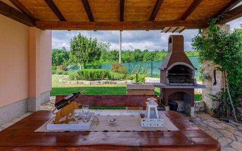 Villa Malini: Plant, Building, Table, Property, Wood, Shade, Interior Design, Porch, Outdoor Furniture, Tree
