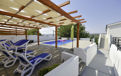 Nina: Property, Sky, Shade, Outdoor Furniture, Building, Interior Design, Wood, Tree, Chair, Urban Design