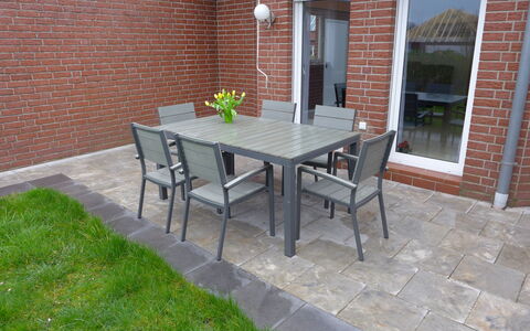 Nilles: Furniture, Table, Building, Chair, Plant, Outdoor Table, Road Surface, Window, Brick, Outdoor Furniture