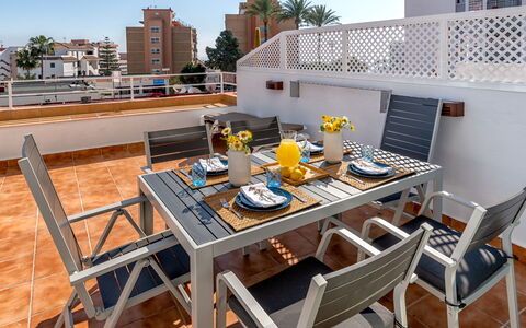Lola Playa: Furniture, Table, Building, Property, Sky, Outdoor Table, Chair, Wood, Outdoor Furniture, Tableware