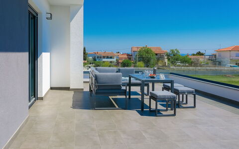 Ella Premantura: Sky, Building, Table, Plant, Shade, Chair, Interior Design, Outdoor Furniture, Tree, Floor