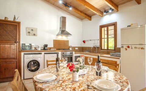 Es Puig Mancor: Property, Cabinetry, Table, Furniture, Countertop, Plant, Tableware, Wood, Kitchen, Lighting