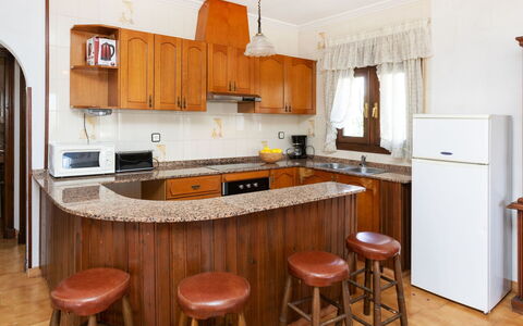 Castilla: Countertop, Cabinetry, Furniture, Table, Refrigerator, Kitchen, Kitchen Appliance, Wood, Interior Design, Flooring