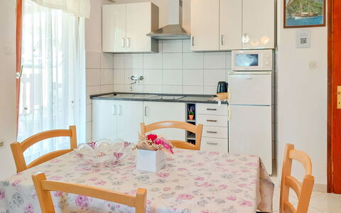 Kuki: Furniture, Cabinetry, Property, Countertop, Refrigerator, Table, Kitchen Appliance, Interior Design, Chair, Kitchen