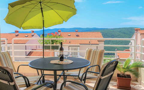 Egle: Plant, Sky, Table, Furniture, Property, Cloud, Building, Flowerpot, Chair, Umbrella