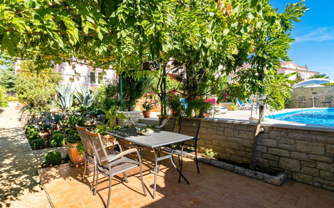 Poreč 606: Table, Plant, Furniture, Flowerpot, Chair, Sky, Building, Outdoor Furniture, Outdoor Table, Shade