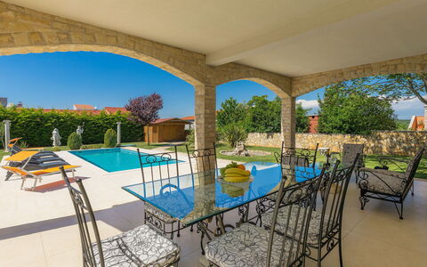 Libera: Plant, Furniture, Property, Table, Water, Chair, Swimming Pool, Shade, Outdoor Furniture, Lighting