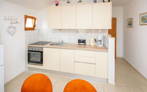 Antonio: Countertop, Cabinetry, Furniture, Property, Sink, Kitchen, Wood, Orange, Kitchen Appliance, Flooring