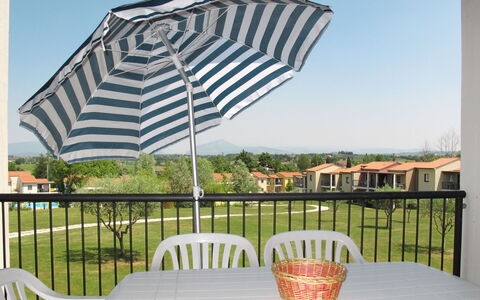 Peschiera del Garda 652: Table, Sky, Plant, Property, Furniture, Light, Outdoor Table, Outdoor Furniture, Shade, Umbrella