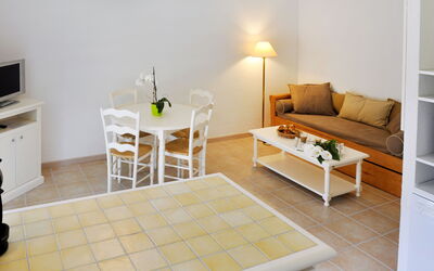 Marina di Santa Giulia 701.1: Room, Furniture, Property, Floor, Interior Design, Product, Tile, Yellow, Table, Living Room