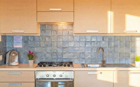 Porto Pozzo 618: Kitchen, Countertop, Kitchen Appliance, Cabinetry, Flooring, Major Appliance, Interior Design, Kitchen Sink, Floor, Tile