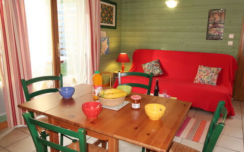 Le Chalet: Table, Furniture, Property, Chair, Couch, Wood, Curtain, Textile, Window, Orange