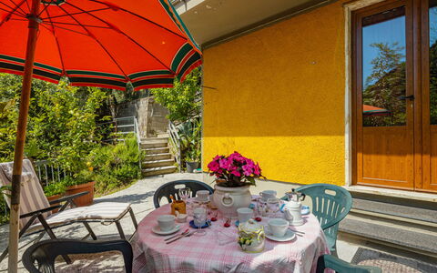 La Sperduta: Table, Plant, Furniture, Property, Flower, Chair, Umbrella, Building, Flowerpot, Window