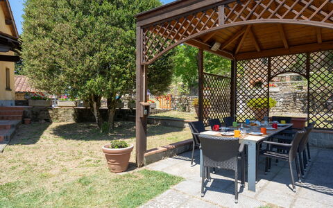 Villa: Plant, Sky, Table, Shade, Tree, Botany, Outdoor Table, Wood, Outdoor Furniture, Leisure