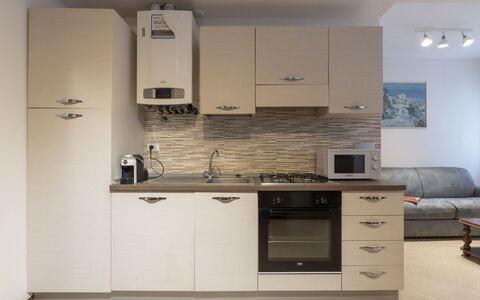 Casa dalla Mamma: Cabinetry, Property, Countertop, Furniture, Sink, Couch, Tap, Kitchen Stove, Wood, Interior Design
