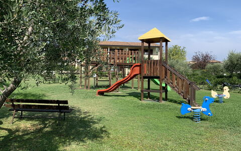 Moniga del Garda 653: Sky, Plant, Shade, Cloud, Tree, Outdoor Bench, Land Lot, Playground, Chute, Building