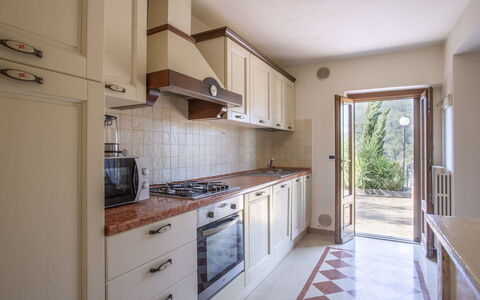 L'Amorosa: Countertop, Cabinetry, Property, Furniture, Kitchen, Kitchen Appliance, Kitchen Stove, Building, Wood, Drawer