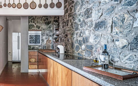 Vistamare: Kitchen, Countertop, Ceiling, Natural Material, Cabinetry, Tile, Light Fixture, Plumbing Fixture, Wood Stain, Stone Wall