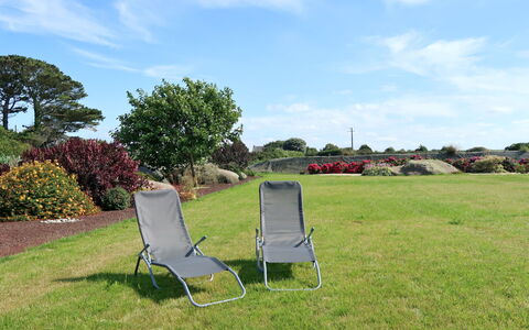 L'Oasis: Property, Grass, Sky, Lawn, Chair, Tree, Folding Chair, Land Lot, Real Estate, Furniture