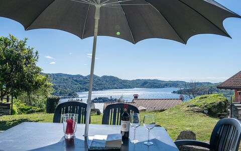Monte San Giulio: Sky, Water, Plant, Furniture, Table, Property, Umbrella, Light, Chair, Nature