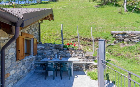 Rinaldo: Plant, Table, Furniture, Window, Outdoor Table, Tree, Shade, Outdoor Furniture, Wood, Grass