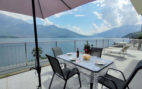 Gera Lario 618: Table, Sky, Furniture, Property, Water, Chair, Mountain, Azure, Cloud, Shade
